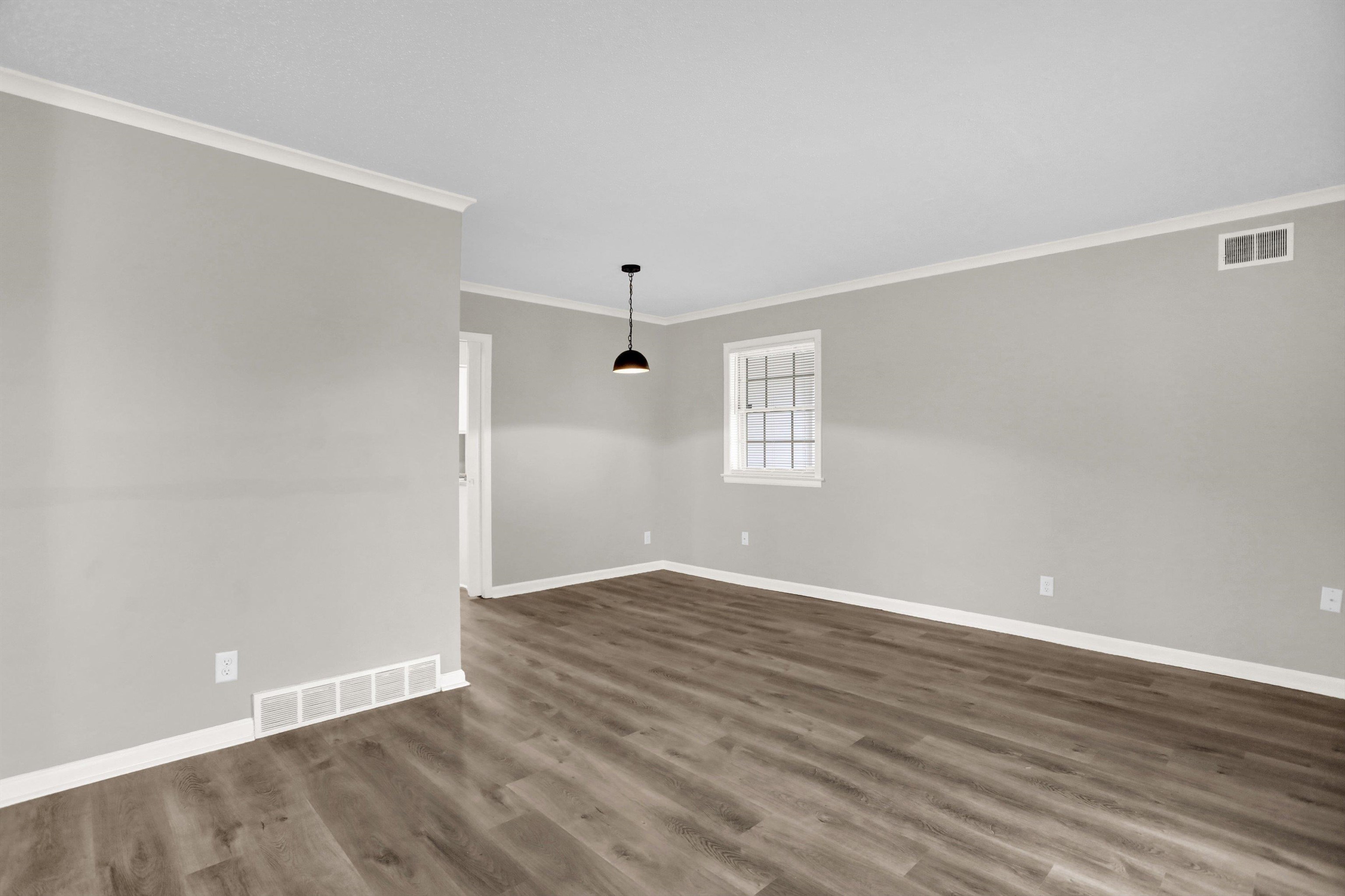 2853 Clearbrook Street Memphis, TN 38118 - Photo 6 of 30 Spare room featuring dark wood-style floors, baseboards, and visible vents