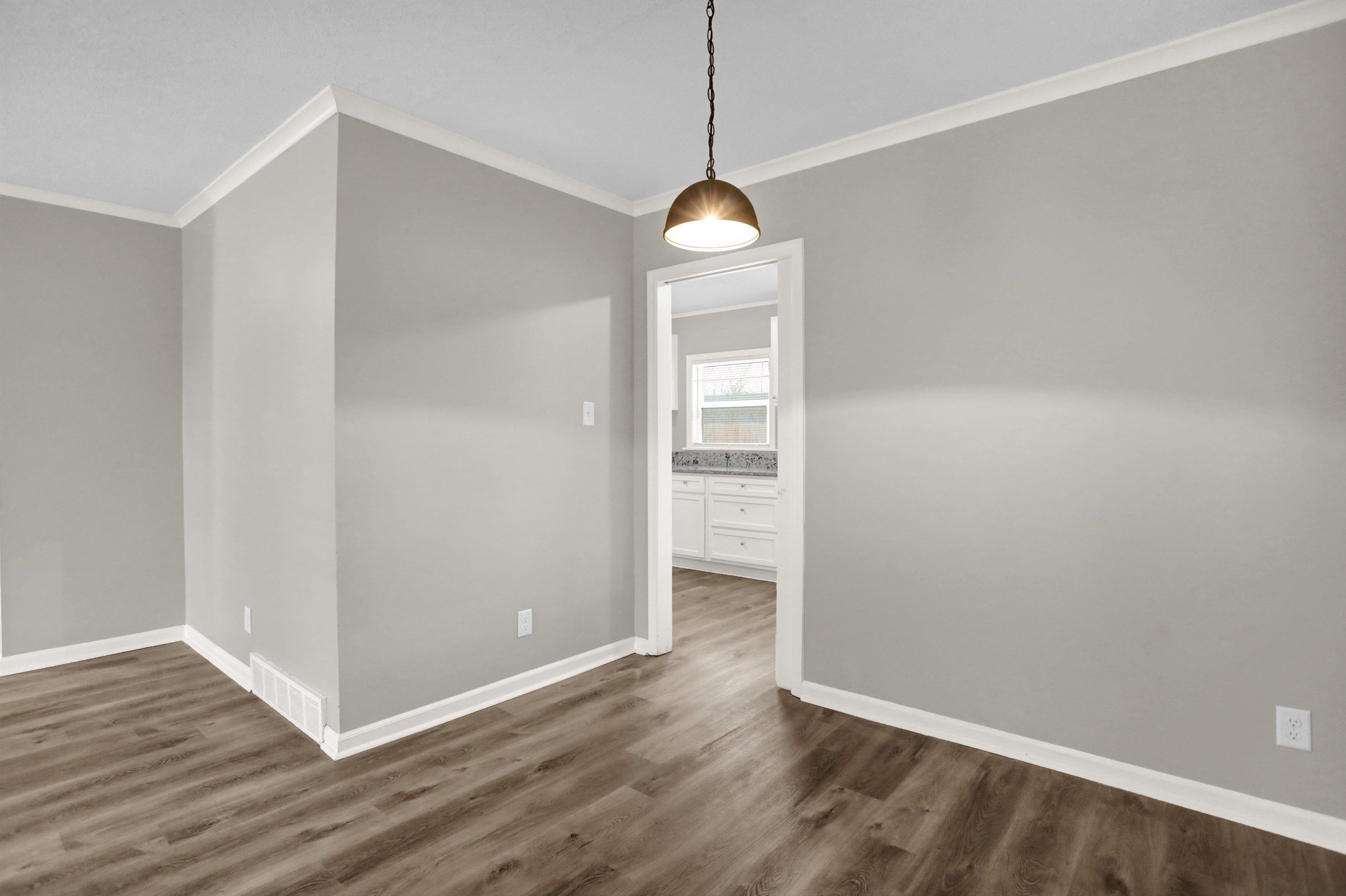 2853 Clearbrook Street Memphis, TN 38118 - Photo 8 of 30 Unfurnished dining area with dark wood-style floors, ornamental molding, and baseboards