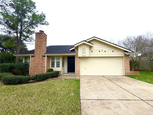 a front view of a house with a garden and plants