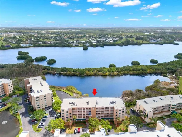 an aerial view of a houses with a lake view