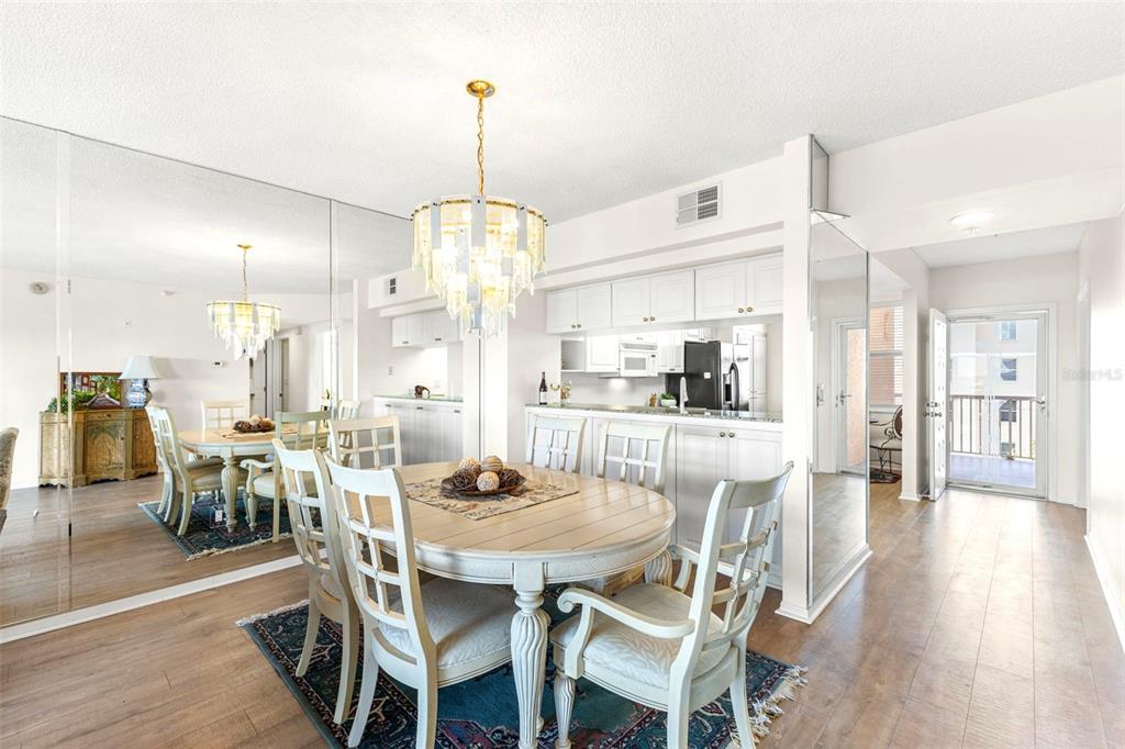 6475 Shoreline Drive, Unit 5403 St. Petersburg, FL 33708 - Photo 14 of 46 a view of a dining room and livingroom with furniture wooden floor kitchen chandelier
