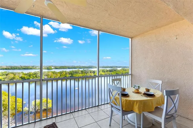 a view of a balcony dining table and chairs