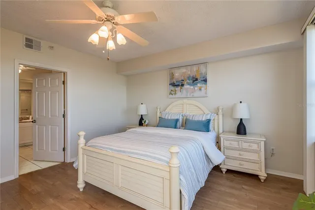 a spacious bathroom with a granite countertop sink a mirror and a shower