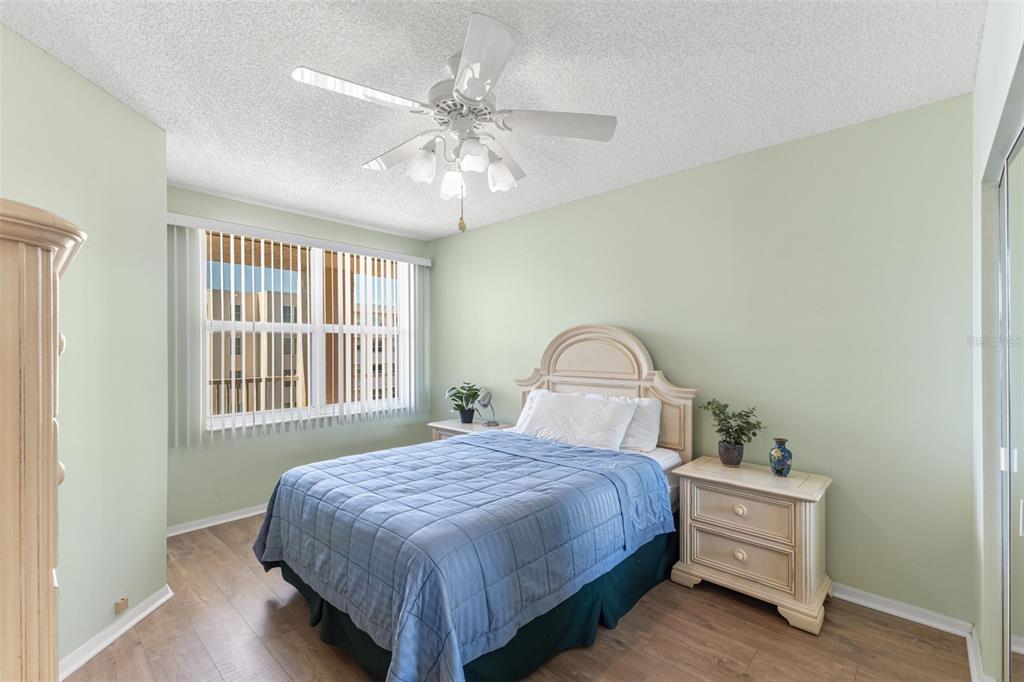 6475 Shoreline Drive, Unit 5403 St. Petersburg, FL 33708 - Photo 27 of 46 a bedroom with a bed and a dresser