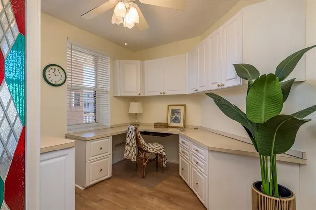 a view of a hallway with closet and a living room
