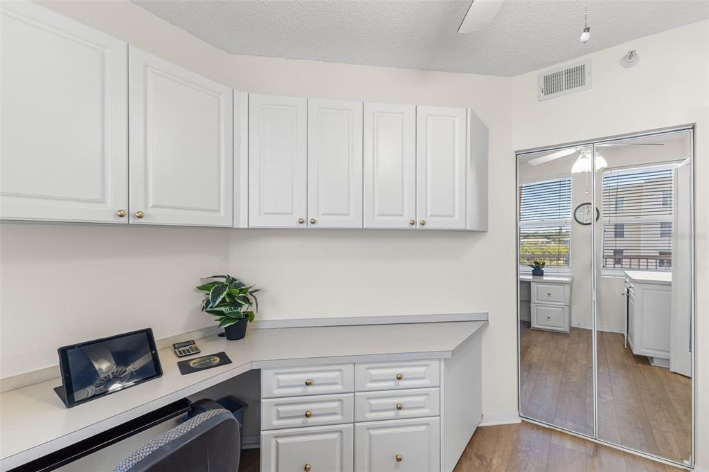 6475 Shoreline Drive, Unit 5403 St. Petersburg, FL 33708 - Photo 30 of 46 a kitchen with stainless steel appliances white cabinets and a stove top oven