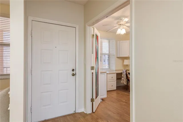 a view of a hallway with wooden floor