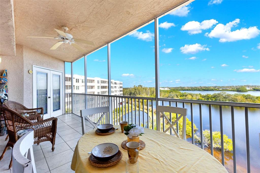 6475 Shoreline Drive, Unit 5403 St. Petersburg, FL 33708 - Photo 3 of 46 a view of a balcony dining table and chairs