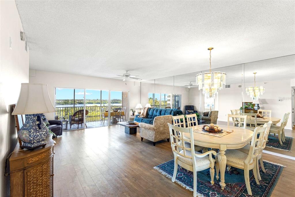 6475 Shoreline Drive, Unit 5403 St. Petersburg, FL 33708 - Photo 6 of 46 a dining room with furniture window and wooden floor