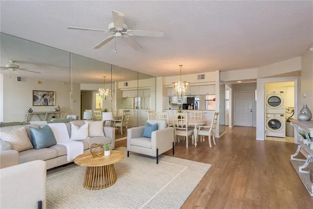 a view of a dining room with furniture wooden floor and chandelier