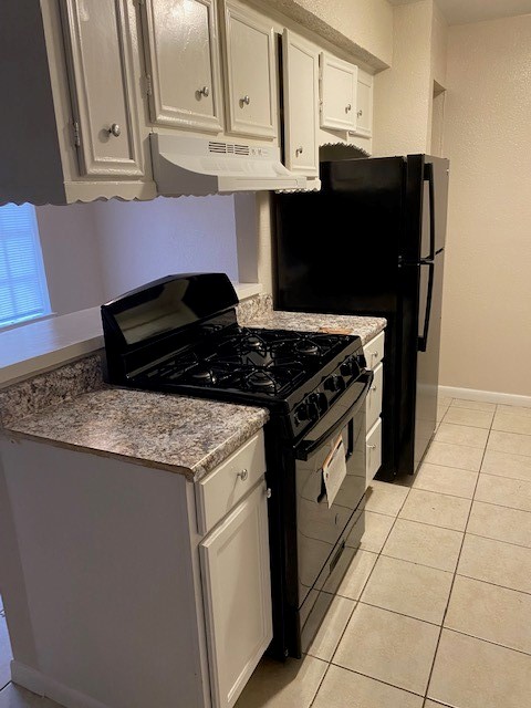 3206 Lobit Drive, Unit 42 Dickinson, TX 77539 - Photo 3 of 19 a kitchen with granite countertop a stove and a cabinets