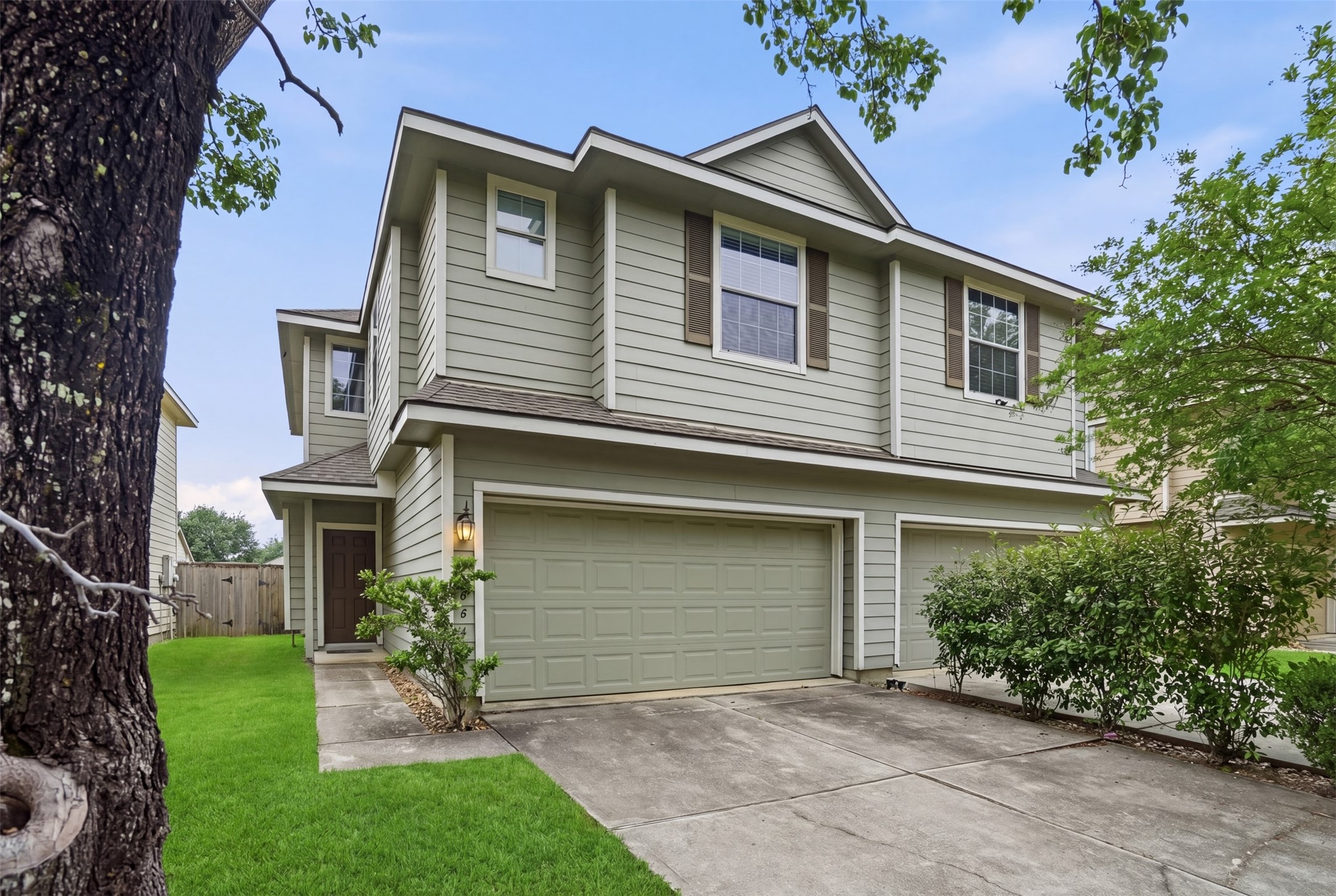 13084 Peppergate Lane Houston, TX 77044 - Photo 2 of 10 a front view of a house with a yard and garage