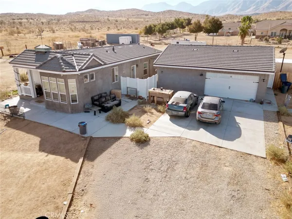 an aerial view of a house with a garden and mountain view