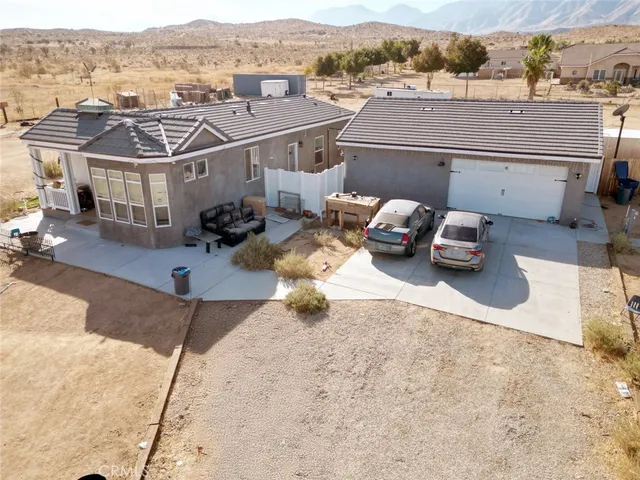 an aerial view of a house with a garden and mountain view