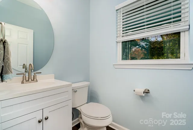 a bathroom with a sink a mirror and a toilet