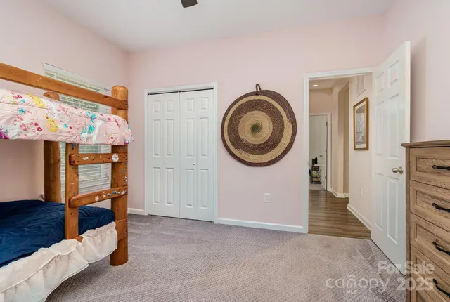 a view of a livingroom with wooden floor and a large window