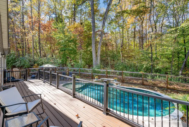 a view of house with deck and outdoor space