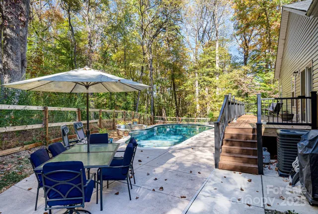 a view of backyard with seating space and trees