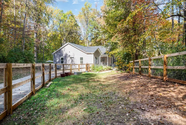 a view of house with backyard and deck