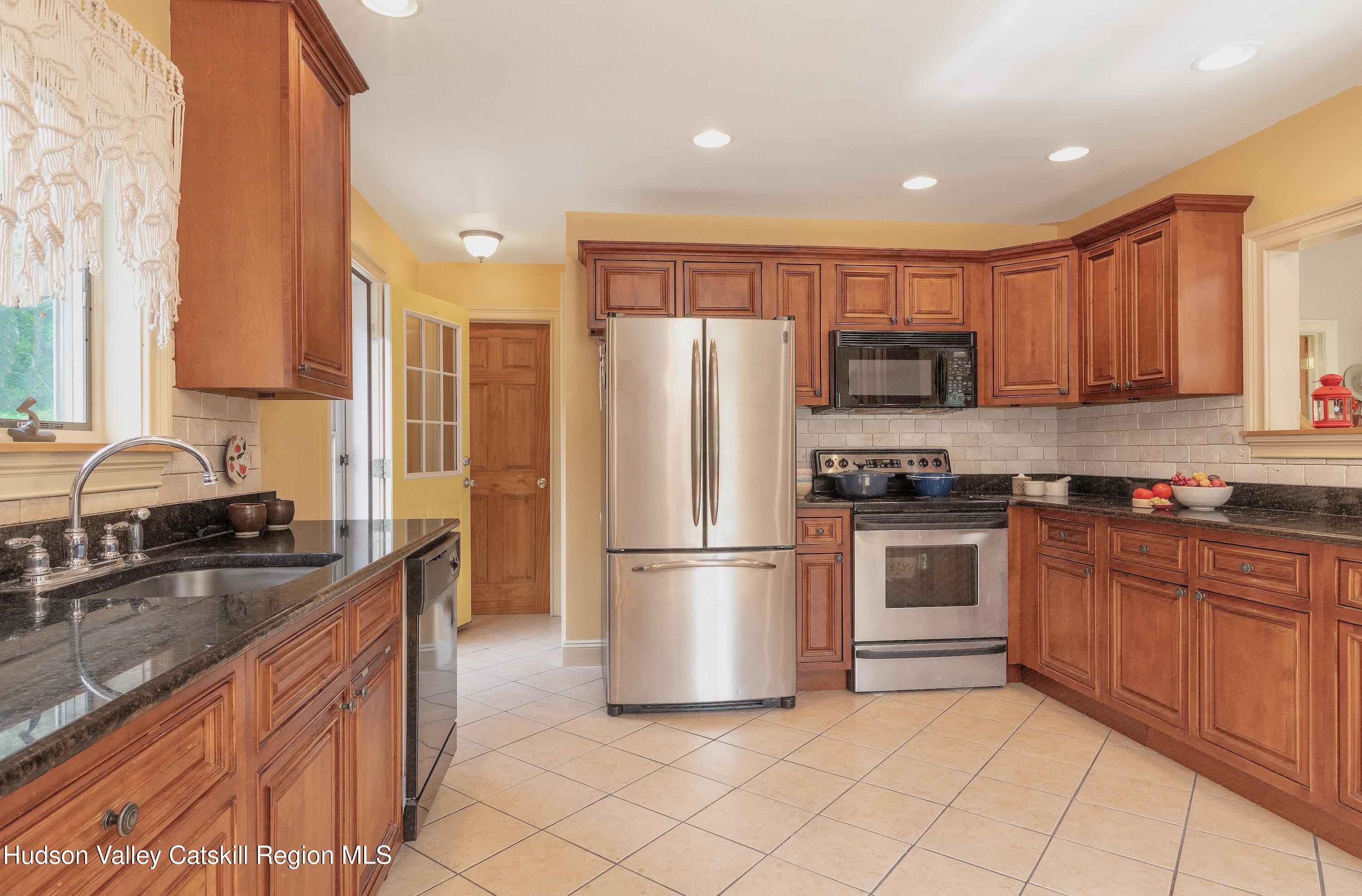 688 Churchland Road Saugerties, NY 12477 - Photo 11 of 37 a kitchen with stainless steel appliances granite countertop a refrigerator sink and stove