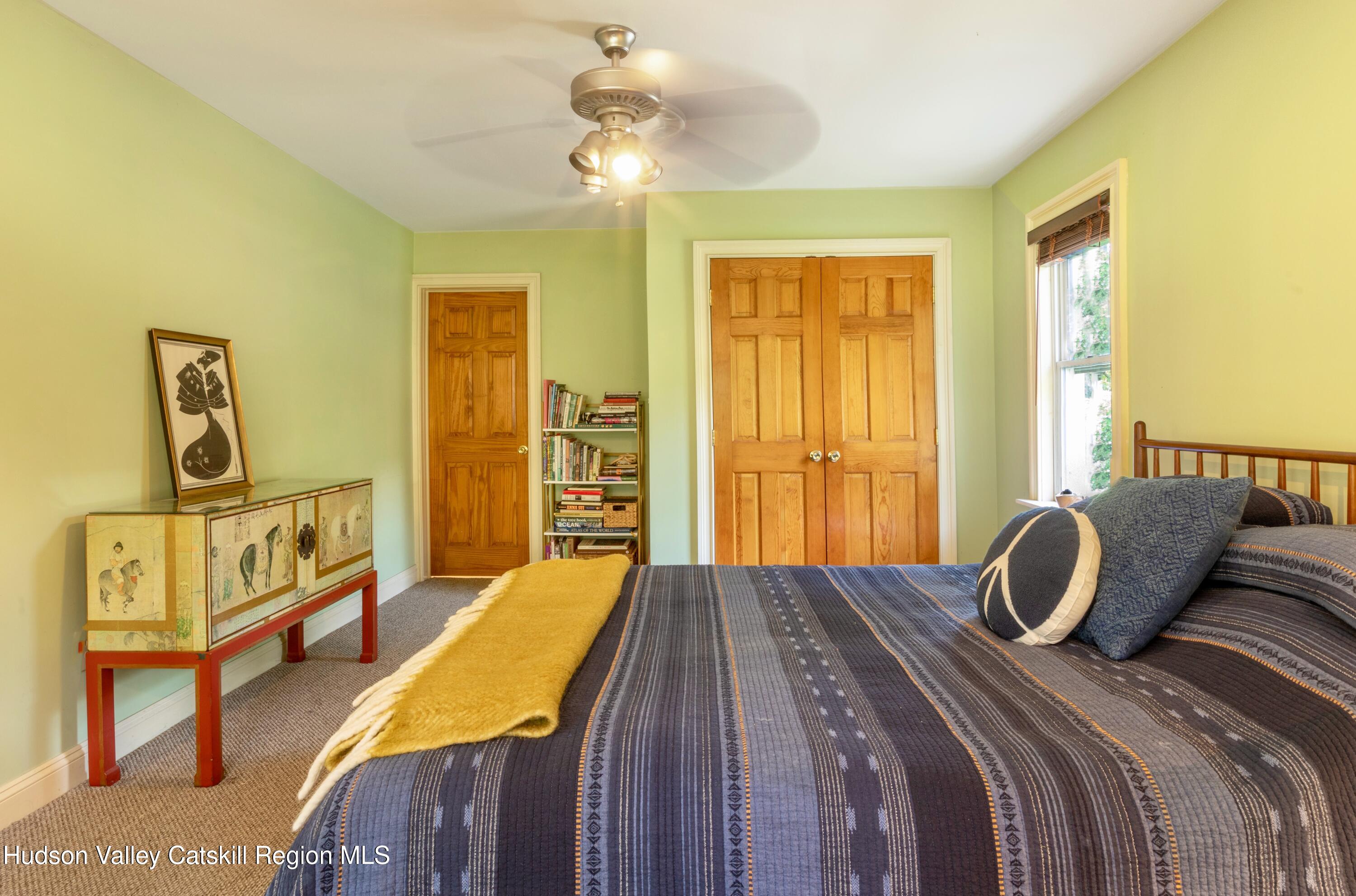 688 Churchland Road Saugerties, NY 12477 - Photo 13 of 37 a bedroom with a bed a dresser with wooden floor