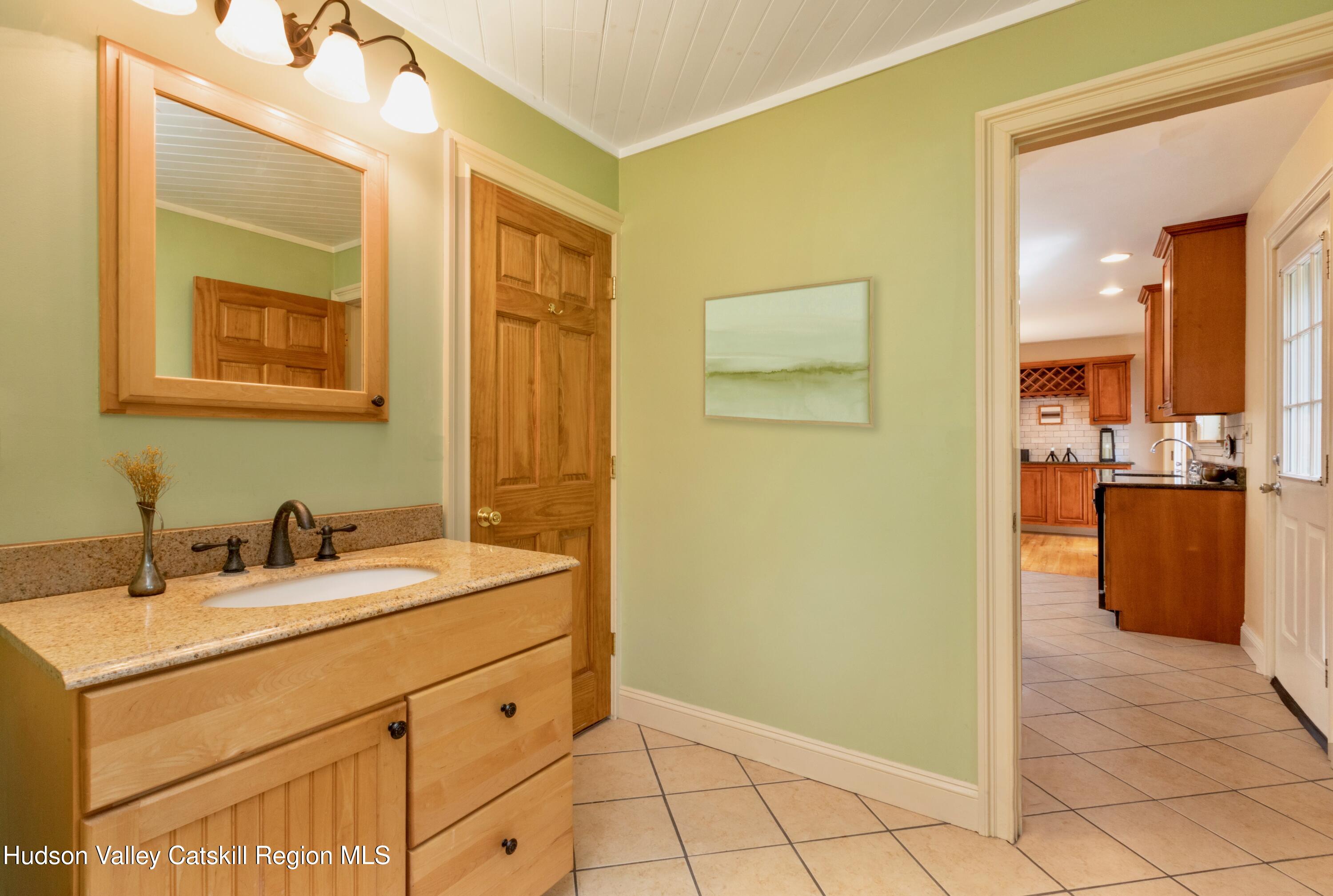 688 Churchland Road Saugerties, NY 12477 - Photo 15 of 37 a bathroom with a sink and a mirror