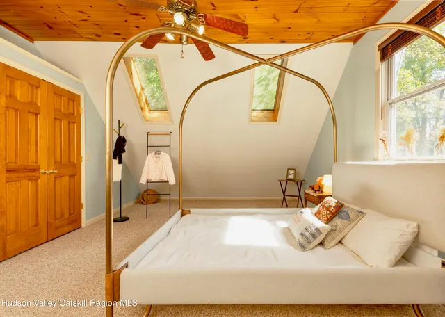 a bedroom with a bed and dresser with mirror