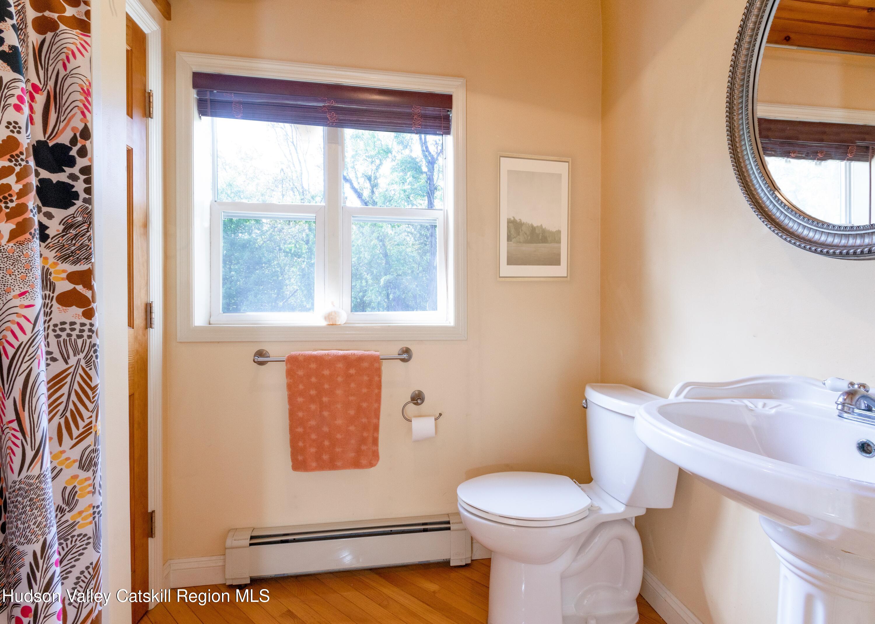 688 Churchland Road Saugerties, NY 12477 - Photo 23 of 37 a white toilet sitting next to a bathroom sink