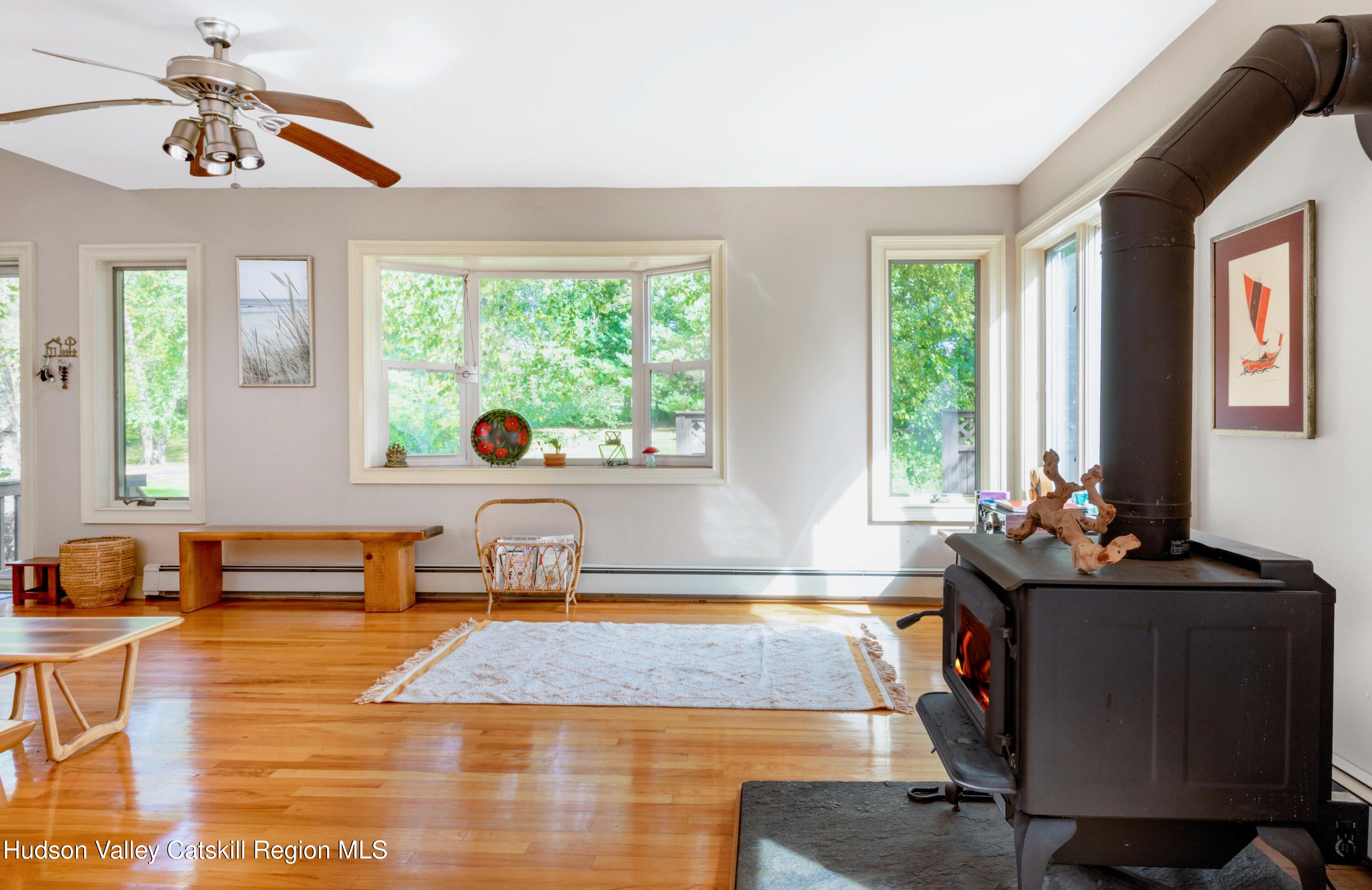 688 Churchland Road Saugerties, NY 12477 - Photo 6 of 37 a living room with furniture and a window