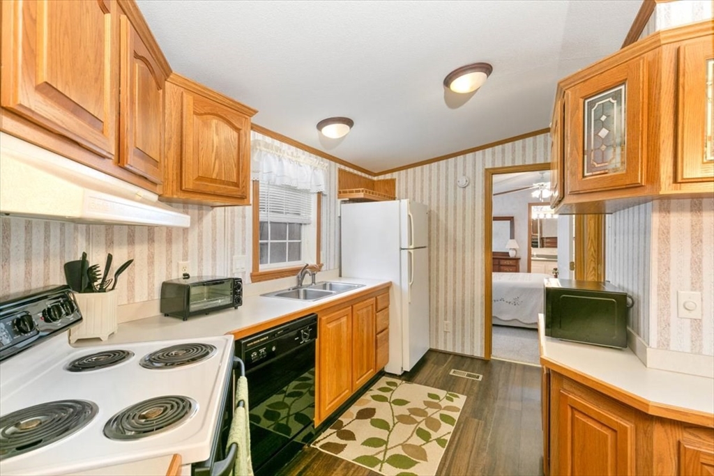 38 Rosemary Street Salem, NH 03079 - Photo 16 of 36 a kitchen with stainless steel appliances granite countertop a sink and cabinets