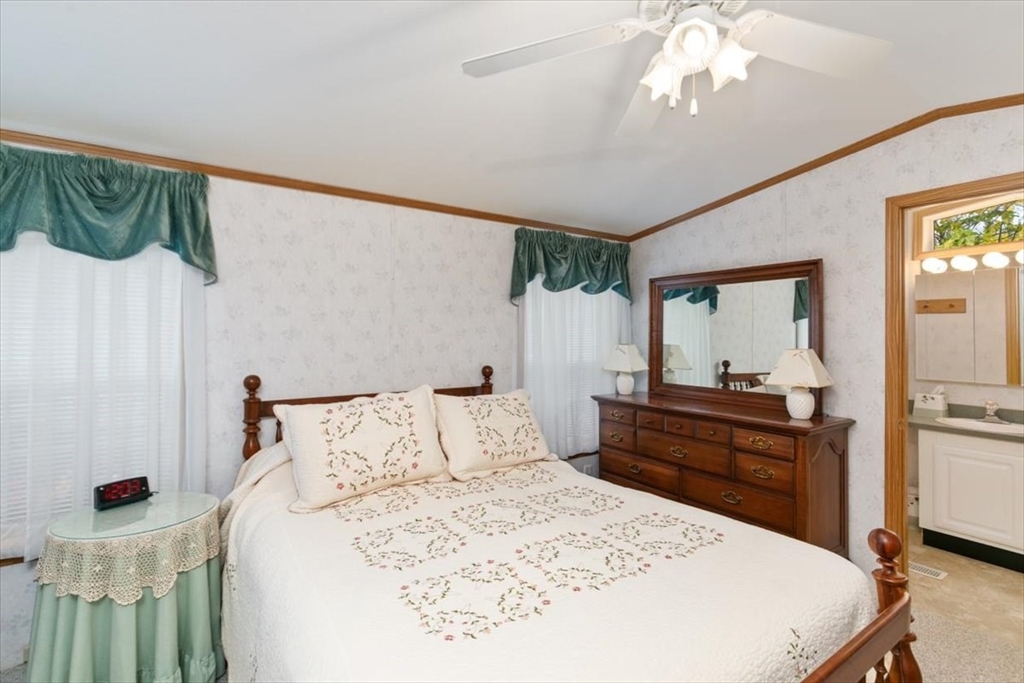 38 Rosemary Street Salem, NH 03079 - Photo 19 of 36 a bedroom with a bed and a chandelier