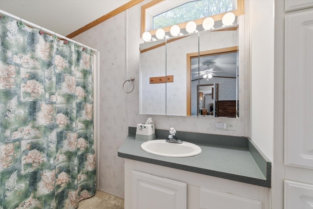 38 Rosemary Street Salem, NH 03079 - Photo 22 of 36 a bathroom with a sink and a mirror