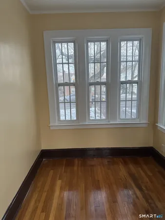 a view of room with window and wooden floor