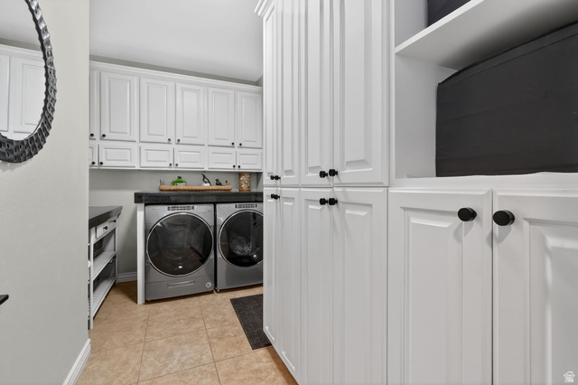 14738 Tangle Hill Road Herriman, UT 84096 - Photo 32 of 66 Laundry room featuring extensive white cabinetry, tile flooring, dark countertops, and built-in shelving