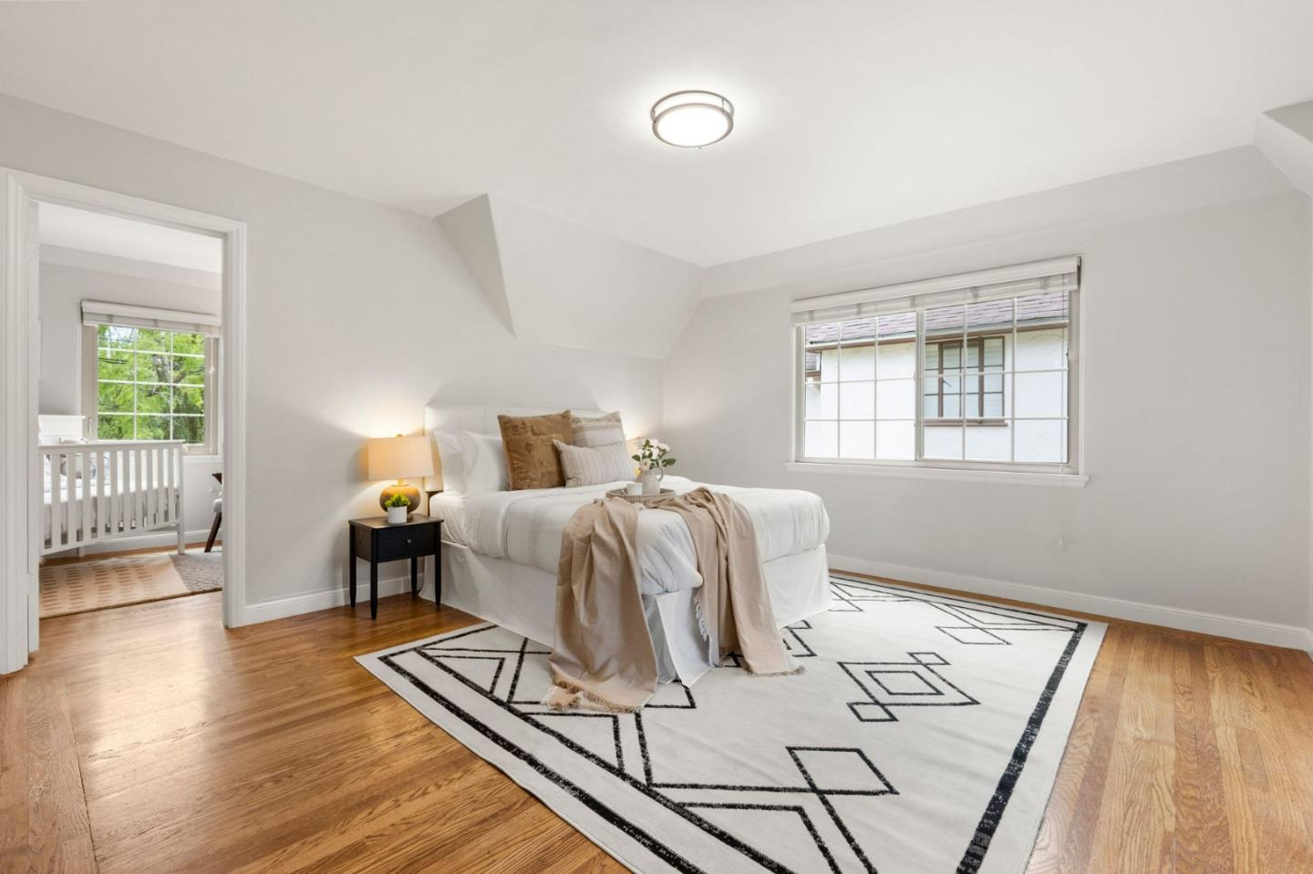 796 Willborough Road Burlingame, CA 94010 - Photo 16 of 31 a bedroom with a bed and wooden floor