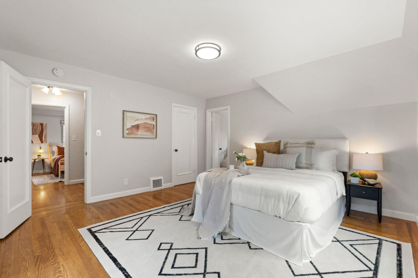 796 Willborough Road Burlingame, CA 94010 - Photo 17 of 31 a bedroom with a bed and wooden floor