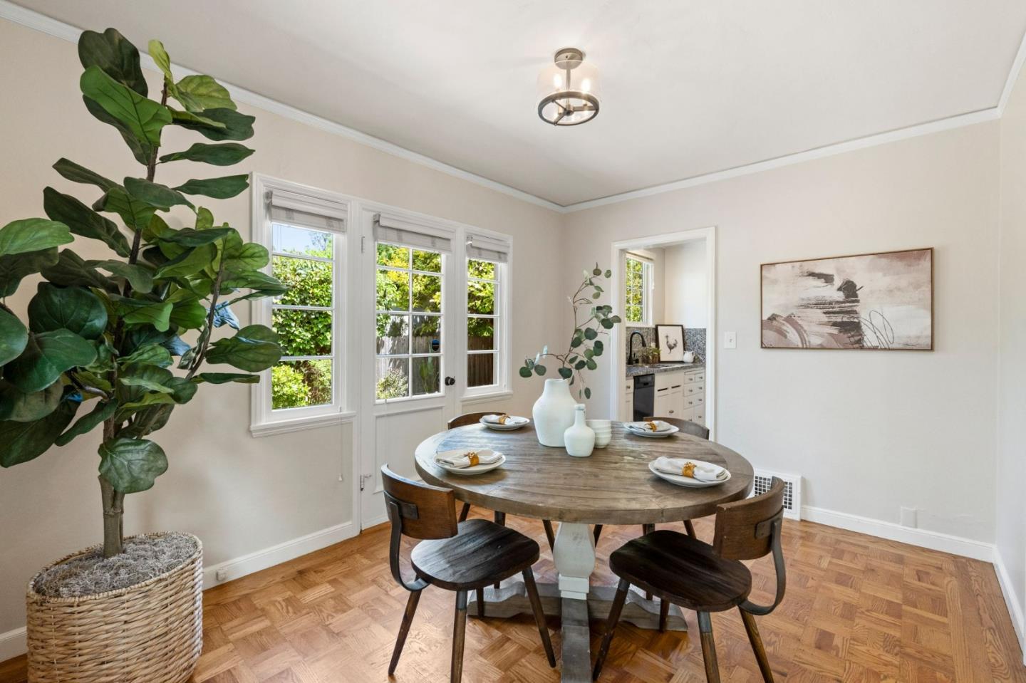 796 Willborough Road Burlingame, CA 94010 - Photo 6 of 31 a dining room with furniture potted plants and wooden floor