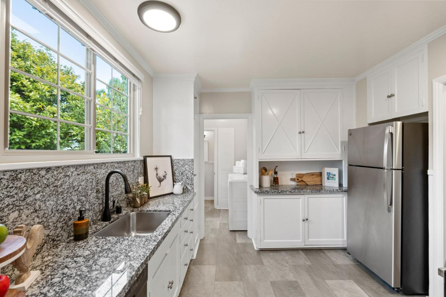 796 Willborough Road Burlingame, CA 94010 - Photo 8 of 31 a kitchen with stainless steel appliances granite countertop a sink stove and refrigerator