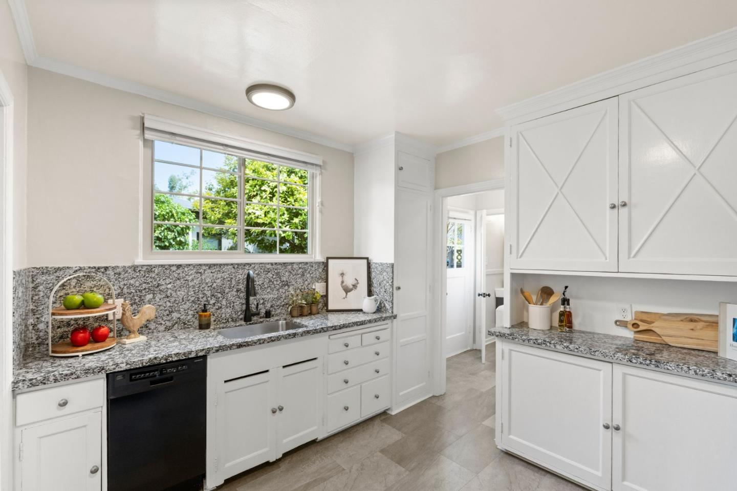 796 Willborough Road Burlingame, CA 94010 - Photo 10 of 31 a kitchen with a sink a stove a window and cabinets