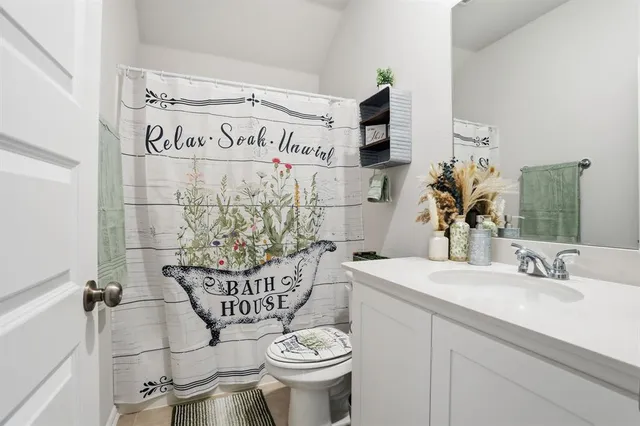 a bathroom with a sink a toilet and mirror