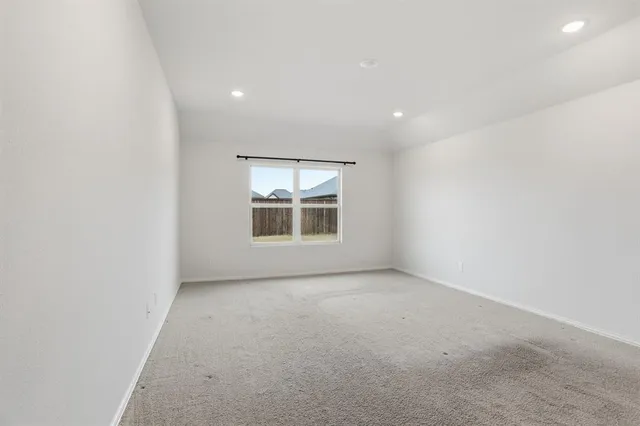 an empty room with a empty space and windows