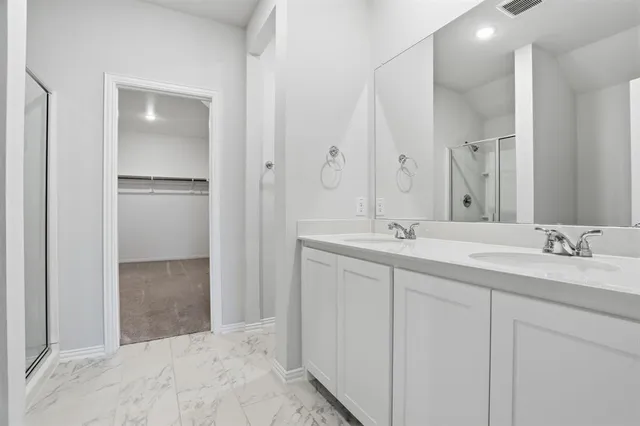 a bathroom with a double vanity sink and mirror