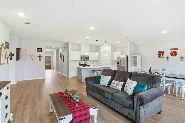a living room with furniture and kitchen view