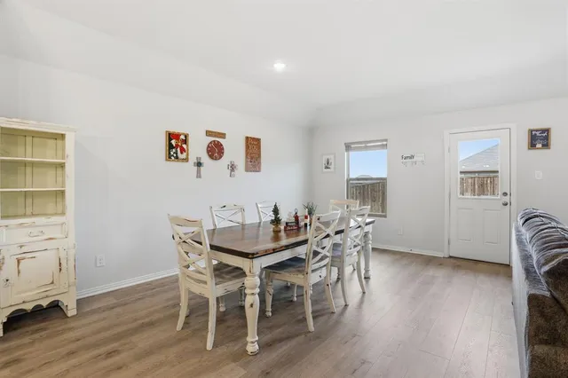 a view of a dining room with furniture and wooden floor