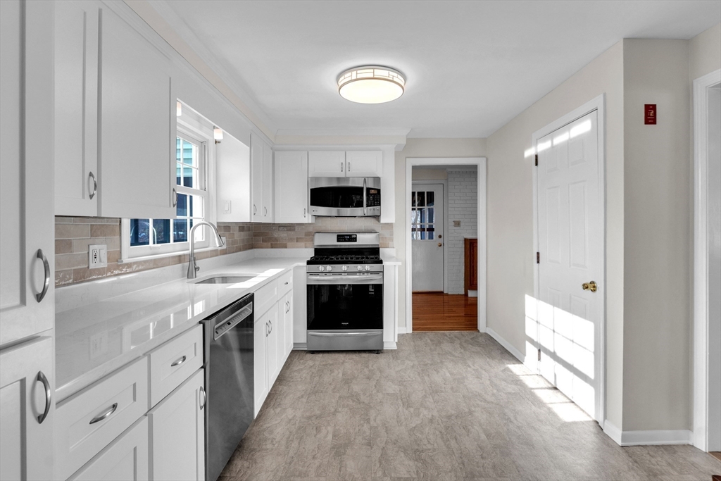 36 Cider Mill Road Framingham, MA 01701 - Photo 13 of 42 a kitchen with granite countertop a sink and a stove top oven