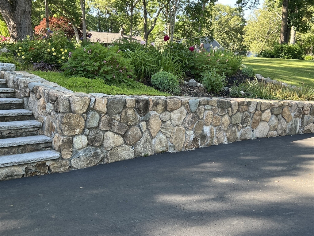 36 Cider Mill Road Framingham, MA 01701 - Photo 36 of 42 a view of a yard with a bench