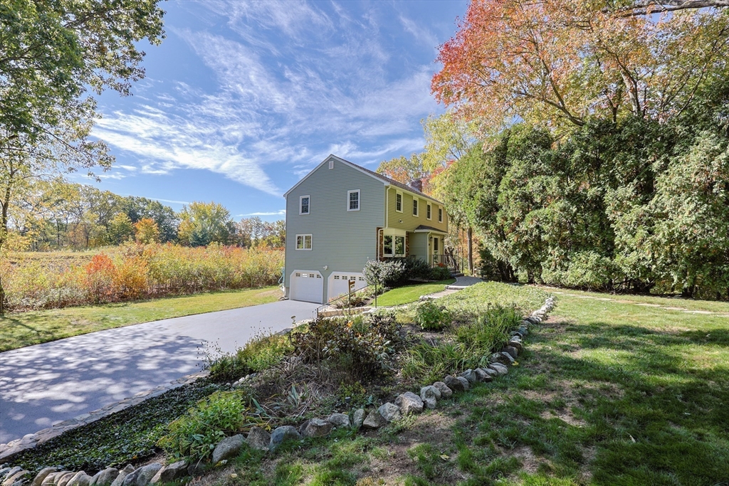 36 Cider Mill Road Framingham, MA 01701 - Photo 41 of 42 a front view of a house with a yard and pathway