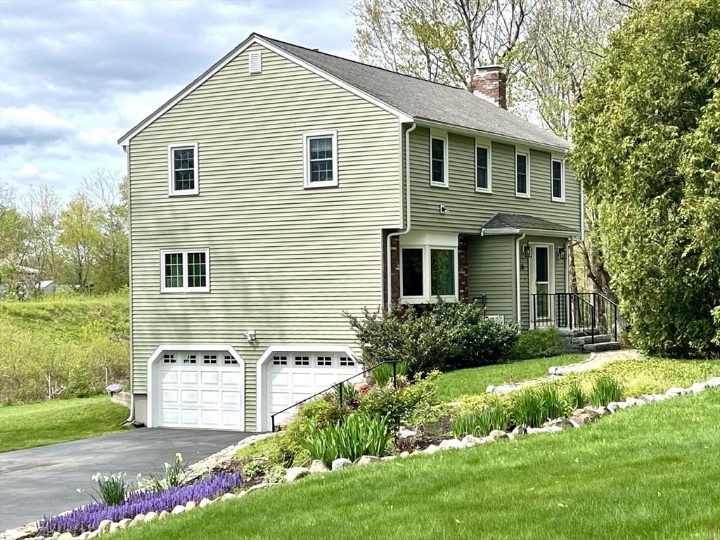 36 Cider Mill Road Framingham, MA 01701 - Photo 5 of 42 a front view of a house with a yard