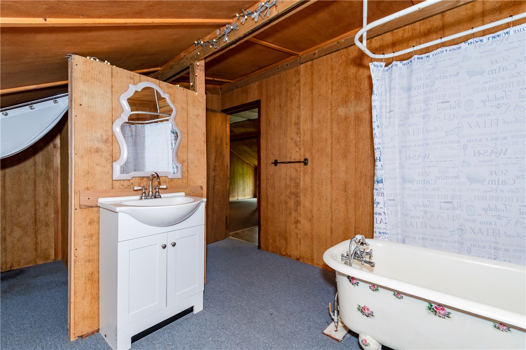 6750 Little Twin Road Germantown, OH 45327 - Photo 62 of 88 Rustic bathroom featuring wood paneling and a claw-foot tub offers a unique aesthetic.