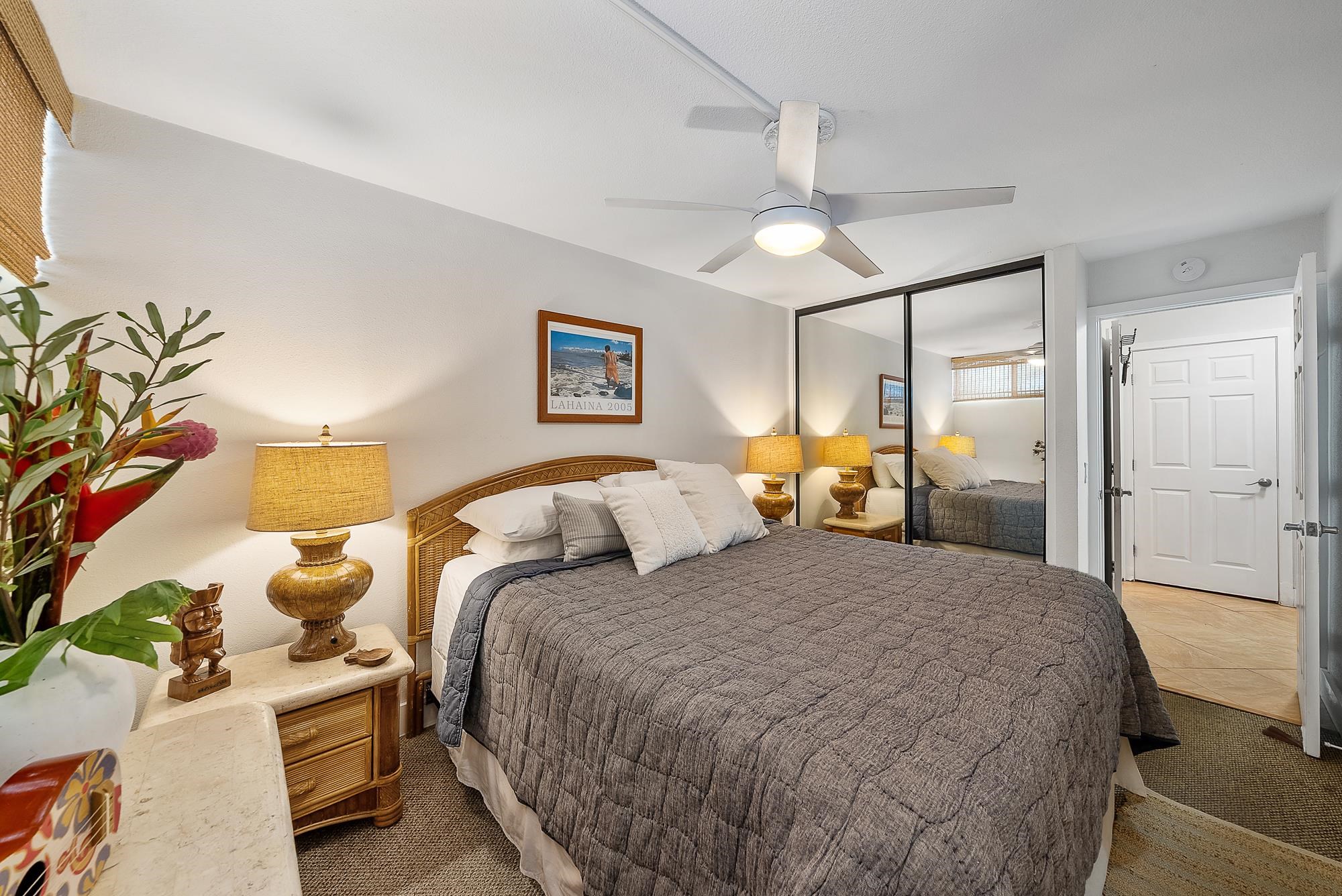 4471 Lower Honoapiilani Road, Unit 118 Lahaina, HI 96761 - Photo 14 of 41 a bedroom with a bed and a chandelier